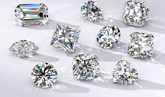 A dazzling assortment of diamonds in various shapes, including emerald, princess, round, cushion, pear, oval, marquise, radiant, asscher, and heart, beautifully capturing their brilliance and sparkle.